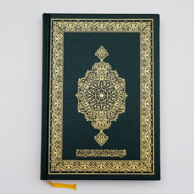 Medine 'de beyaz bir arka planda izole edilmiş, orta büyüklükte, orijinal yeşil bir Kur' an. en üstteki görünüm.