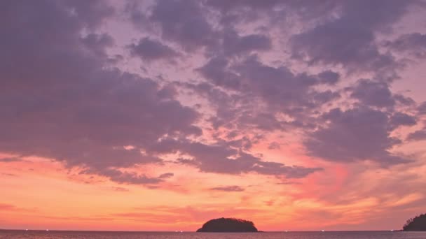 夜は島の上空のカラフルな雲 カタビーチの浦島の裏側に沈む黄色い太陽 島の背景の上の紫色の雲 — ストック動画