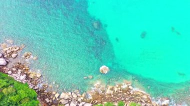 Colorful turquoise sea. Gradient color. sea texture, abstract nature background. aerial top view smooth waves in Phuket sea hit on the rocks. color sea light rays and other atmospheric effects.