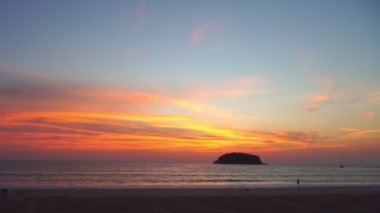 scenery yellow sun going down to the sea.beautiful moving cloud in sweet sky at sunset in Kata beach Phuket Thailand4k stock footage video in travel concept.