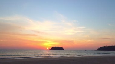 scenery yellow sun going down to the sea.beautiful moving cloud in sweet sky at sunset in Kata beach Phuket Thailand4k stock footage video in travel concept.