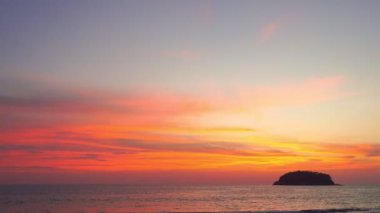 scenery yellow sun going down to the sea.beautiful moving cloud in sweet sky at sunset in Kata beach Phuket Thailand4k stock footage video in travel concept.