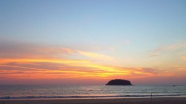 scenery yellow sun going down to the sea.beautiful moving cloud in sweet sky at sunset in Kata beach Phuket Thailand4k stock footage video in travel concept.