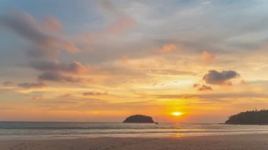 scenery yellow sun going down to the sea.beautiful moving cloud in sweet sky at sunset in Kata beach Phuket Thailand4k stock footage video in travel concept.
