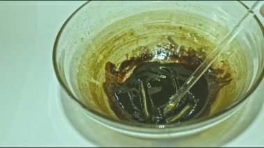 .Using heat to simmer cannabis buds to stimulate cannabinoids. Use a glass rod to stir the cannabis oil..Hemp oil color is dark brown and sticky..hemp oil extraction. Herbs with great benefits