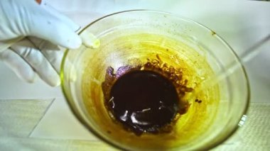 .Using heat to simmer cannabis buds to stimulate cannabinoids. Use a glass rod to stir the cannabis oil..Hemp oil color is dark brown and sticky..hemp oil extraction. Herbs with great benefits