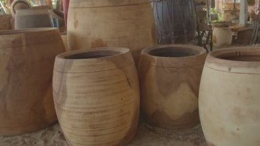 Large pieces of wood were cut into pieces to make various types of drums.forming different types of large wooden drumslarge pile of logs, wooden background.Theatrical drums used in traditional and