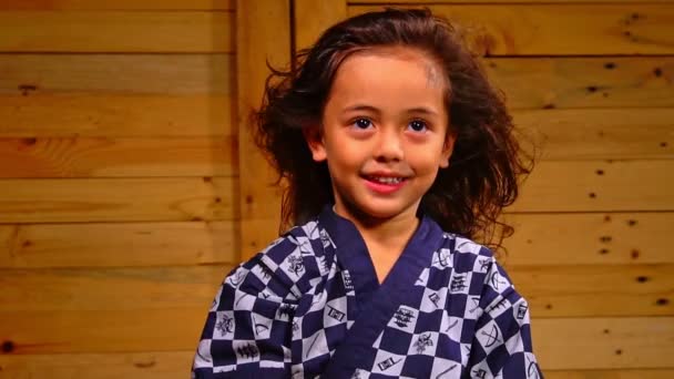 Cute Little Boy Sits Wooden Room Swaying His Hair Slow — Vídeo de stock