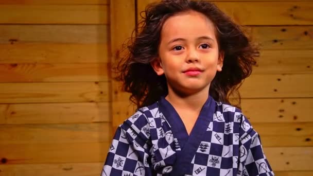 Cute Little Boy Sits Wooden Room Swaying His Hair Slow — Video