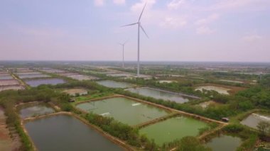 aerial photography wind turbine.Wind turbines generate electricity in a shrimp field near the sea..Wind power generates electricity. Clean energy from nature. .fan in the fields background..