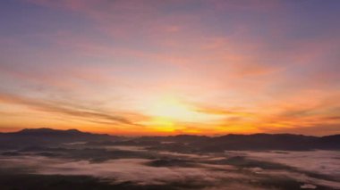 aerial view beautiful sunrise at the horizon of mountain range in Phang Nga Thailand.The mist poured down from the mountains in the morning.beautiful sunrise colorful sky over the mist background.