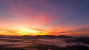 aerial view beautiful sunrise at the horizon of mountain range in Phang Nga Thailand.The mist poured down from the mountains in the morning.beautiful sunrise colorful sky over the mist background.