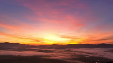 aerial view beautiful sunrise at the horizon of mountain range in Phang Nga Thailand.The mist poured down from the mountains in the morning.beautiful sunrise colorful sky over the mist background.