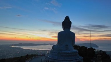 aerial view beautiful sunrise at Phuket big Buddha on the hilltop. Phuket white big Buddha is the famous landmark in Phuket.Aerial panoramic view landscape Phuket big Buddha.