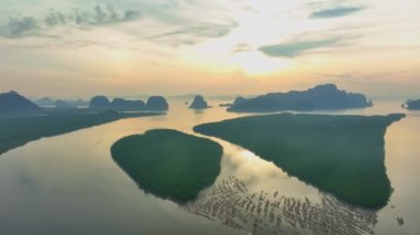 aerial view beautiful sky at twilight above mangrove forest.large canal from mangrove forest connect to Andaman sea.fog flotting above the mangrove forest.4k video colorful sky background.