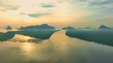 aerial view beautiful sky at twilight above mangrove forest.large canal from mangrove forest connect to Andaman sea.fog flotting above the mangrove forest.4k video colorful sky background.