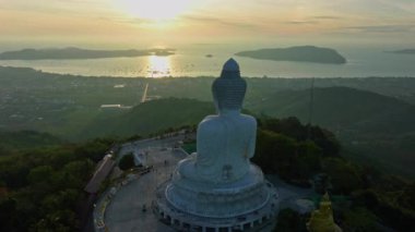 aerial Hyperlapse view around Phuket big Buddha in blue sky background.Phuket white big Buddha is the famous landmark in Phuket. Aerial panoramic view landscape Phuket big Buddha.