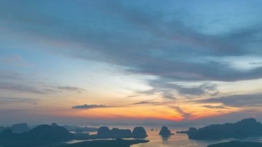 aerial Hyper lapse view over the island.View of the sunrise over a group of islands in Phang Nga Bay.Ban Sam Chong Fishing Village in Phang Nga.4k video islands background.