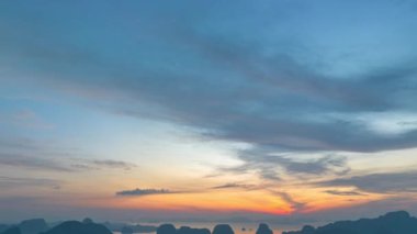 aerial Hyper lapse view over the island.View of the sunrise over a group of islands in Phang Nga Bay.Ban Sam Chong Fishing Village in Phang Nga.4k video islands background.