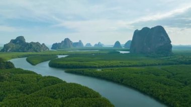 aerial Hyperlapse view above canal in the green field. large canal from mangrove forest connect to Andaman sea.sunet above the group of islands in Phang Nga.4k video colorful sky background.