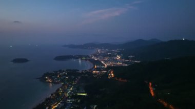 .aerial view The lights twinkled along the three beaches at night..Kata Noi beach, Kata beach and Karon beach..Bright colors along the beach area at night..