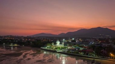 .aerial hyperlapse of a mosque in twilight. .The Rawai Mosque in colorful sunset. A mosque at dawn scenery clouds above mosque..reflecting off the sea is very beautiful.
