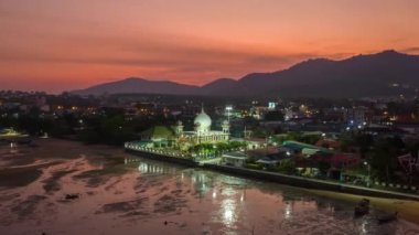 .aerial hyperlapse of a mosque in twilight. .The Rawai Mosque in colorful sunset. A mosque at dawn scenery clouds above mosque..reflecting off the sea is very beautiful.