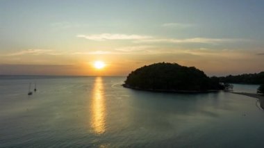 .aerial hyper lapse view beautiful sunset above Kala island at Layan beach Phuket..colorful sky of sunset at horizon.Phuket beach sea Amazing beach, .Beautiful beach Phuket Thailand, Nature and travel concept..