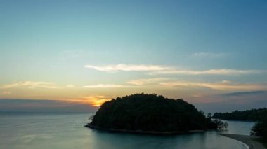 .aerial hyper lapse view beautiful sunset above Kala island at Layan beach Phuket..colorful sky of sunset at horizon.Phuket beach sea Amazing beach, .Beautiful beach Phuket Thailand, Nature and travel concept..