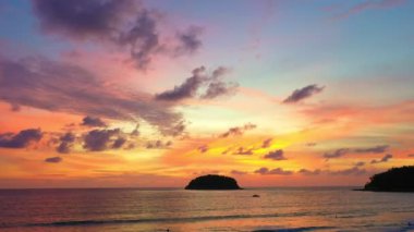 aerial view colorful sky in twilight at Kata beach Phuket..abstract nature background. .Sunset with sweet color light rays and other atmospheric effects over the island..4k video
