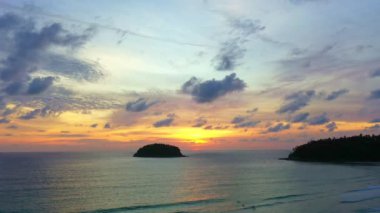 aerial view colorful sky in twilight at Kata beach Phuket..abstract nature background. .Sunset with sweet color light rays and other atmospheric effects over the island..4k video