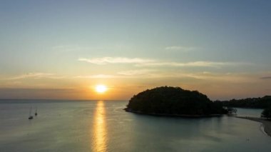 .aerial hyper lapse view beautiful sunset above Kala island at Layan beach Phuket..colorful sky of sunset at horizon.Phuket beach sea Amazing beach, .Beautiful beach Phuket Thailand,t..