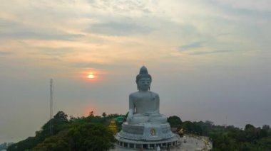 aerial Hyperlapse view around Phuket big Buddha in beautiful sunset.360 degree view on Phuket big Buddha viewpoint.Video clips for travel and religious ideas.smooth sea and sky background.