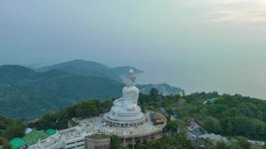 aerial Hyperlapse view around Phuket big Buddha in blue sky background.Phuket white big Buddha is the famous landmark in Phuket. Aerial panoramic view landscape Phuket big Buddha.