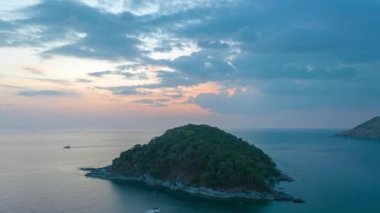 aerial hyperlapse view sunset at Laem Promthep Cape..Promthep cape viewpoint is the most popular viewpoint in Phuket island..time lapse day to night 4K video of Majestic sunset landscape..