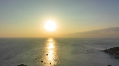 aerial hyperlapse view sunset at Laem Promthep Cape.Promthep cape viewpoint is the most popular viewpoint in Phuket island.time lapse day to night 4K video of Majestic sunset landscape.