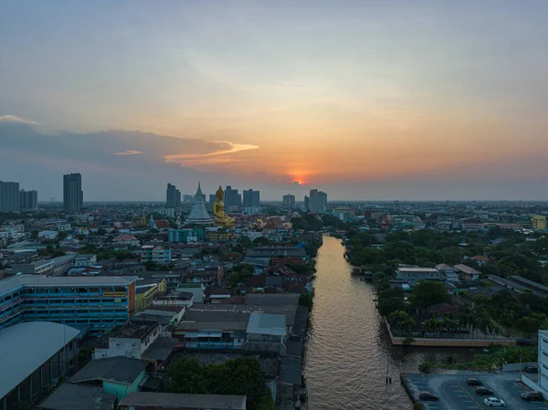 stock image golden big Buddha Wat Paknam Phasi Charoen in sunset. .beautiful sunset reflection on a canal in front big buddha. .scenery sky in twilight background.the one famous landmarks in Thailand..