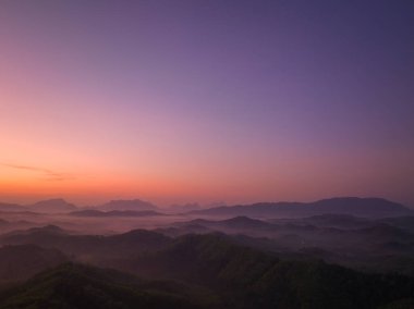 Hava manzarası Şafak vakti vadideki sisli denizin üzerinde gökyüzünde inanılmaz renkler.