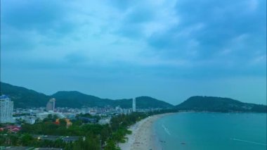 Patong plajı Phuket Tayland 'daki mavi gökyüzünde gökyüzü hiperlapse bulutu Patong Sahili eskiden dünyanın en iyi turizm merkezlerinden biriydi beyaz kumsal yeşil deniz dalgaları arka planda.