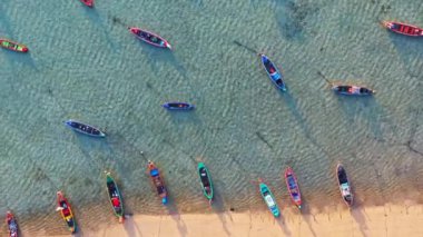 Rawai plajı Phuket Tayland 'da sahilde yüzen balıkçı tekneleri ve turist tekneleriyle sahildeki hava manzarası. Fotoğraf: Yukarıdan insansız hava aracı. Yüksek kalite 4K hava görüntüsü..