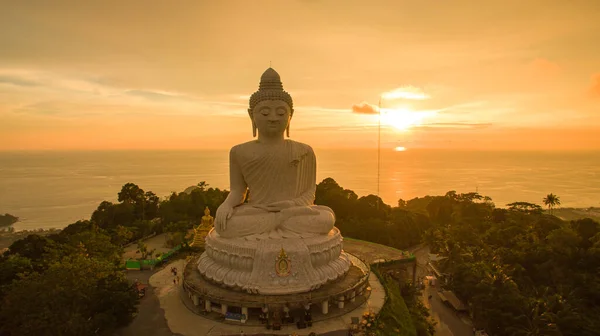 stock image aerial view Phuket big Buddha in beautiful sunset.amazing sun shines through the yellow clouds impact on golden sea surfaceThe beauty of the statue fits perfectly with the charming nature.