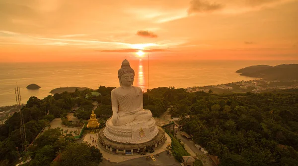 stock image aerial view Phuket big Buddha in beautiful sunset.amazing sun shines through the yellow clouds impact on golden sea surfaceThe beauty of the statue fits perfectly with the charming nature.