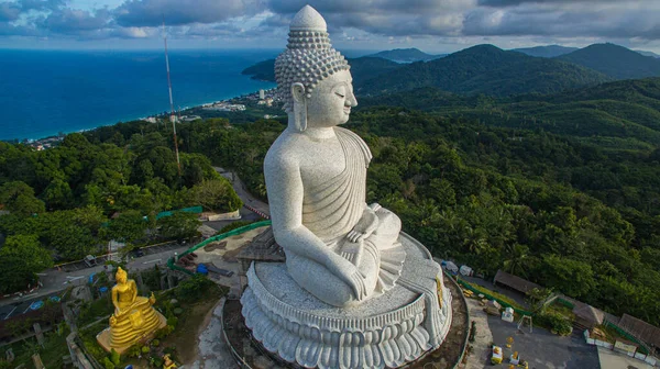 stock image aerial view Phuket Big Buddha is one of the island most important and revered landmarks in Phuket 360 degree view on Phuket big Buddha viewpoint. blue sky blue sea and green forest background.