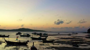 Balıkçı teknelerinin üzerindeki hava manzarası suda güzel bir yansıma yaratıyor. Denizdeki güzel güneş ışığının manzaralı yansıması Phuket denizinde yüzen balıkçı tekneleri.