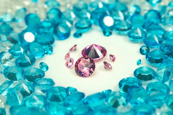 group of pink diamonds arranged in the middle of blue diamonds on a white background