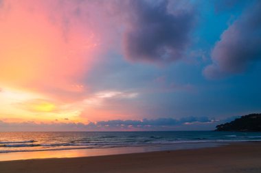 Karon plajının üzerindeki muhteşem pembe gökyüzü Phuket 'in renkli günbatımında