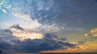 Gün batımında denizin üzerindeki çarpıcı renkli bulutların hızlandırılmış videosu
