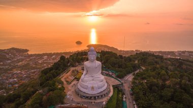 Renkli gündoğumu gökyüzünün havadan görünüşü, arka planda Büyük Buda heykeli ve okyanus. Phuket, Tayland