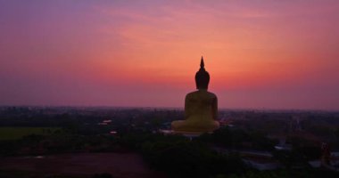 .Güneşin doğuşunda Tayland 'da popüler bir dönüm noktası olan Golden Big Buddha' da gökyüzü pembeydi. Tayland 'ın meşhur pirinç tarlasında altın büyüklüğünde Buda..
