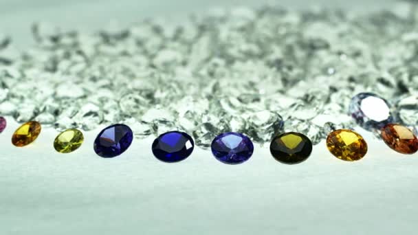 五彩缤纷的宝石排成一排排列在一堆白色钻石前 — 图库视频影像